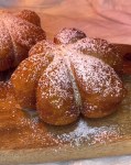 Pumpkin shaped donuts dusted with powdered sugar